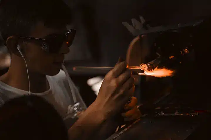 Glassblower scientifically engineering a glass apparatus
